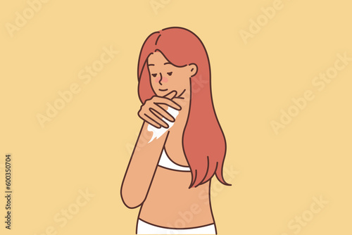Woman uses sunscreen before going at beach or going to pool in sunny summer weather