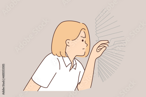 Suspicious woman looks through blinds at window, suffering from paranoia and distrust of neighbors