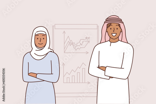 Arabic office workers stand near board with charts talking about marketing strategy of corporation