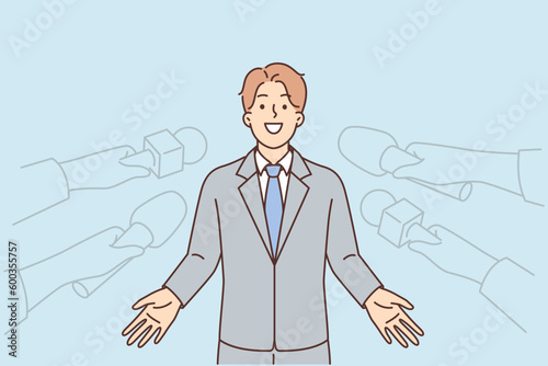 Man politician gives interview to reporters standing near hands with microphones