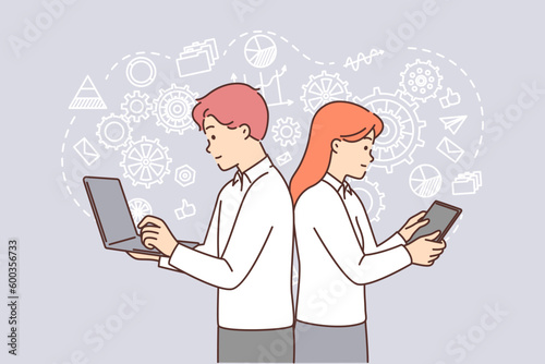 Man and woman with gadgets are doing business brainstorming standing among gears