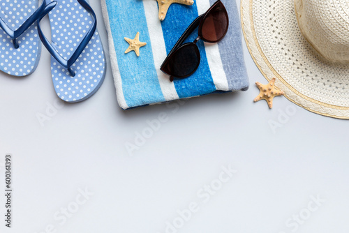 Summer vacation concept flat lay. straw hat beach accessories and towel top view. Space for text. travel concept