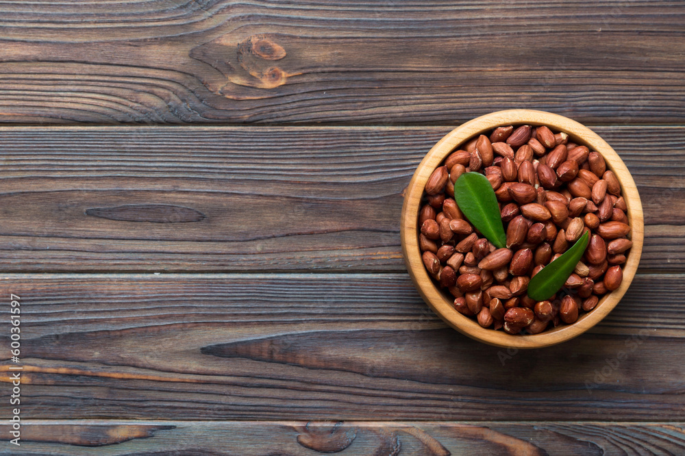 Fresh healthy peanuts in bowl on colored table background. Top view Healthy eating bertholletia concept. Super foods Fresh healthy peanuts in bowl on colored table background. Top view Healthy eating bertholletia concept. Super foods