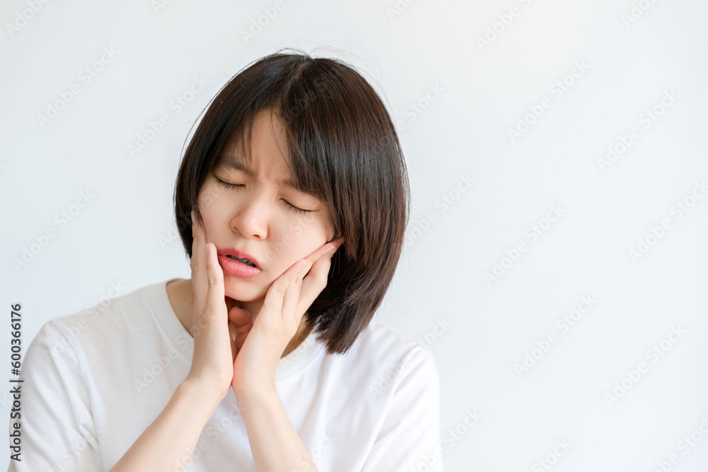 Woman holding her cheek due to toothache. Woman holding her cheek due to toothache.