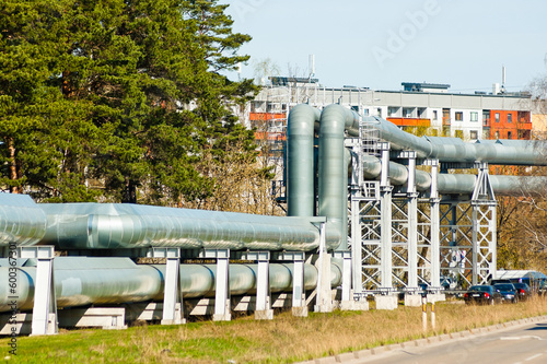 pipeline in the city, in the background of the building, forest and blue sky