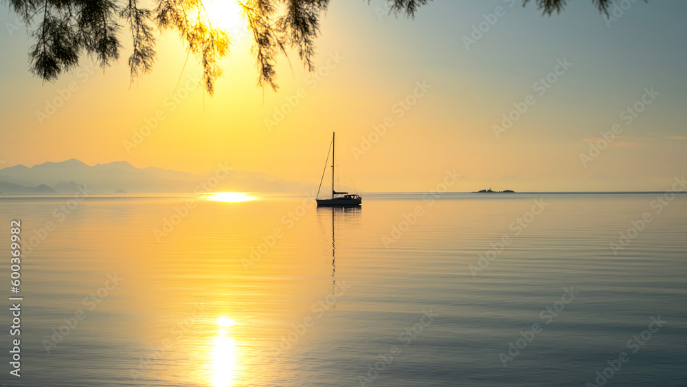Early morning on calm sea, orange sky and sailing yacht, calmness, serenity and meditation - obrazy, fototapety, plakaty 