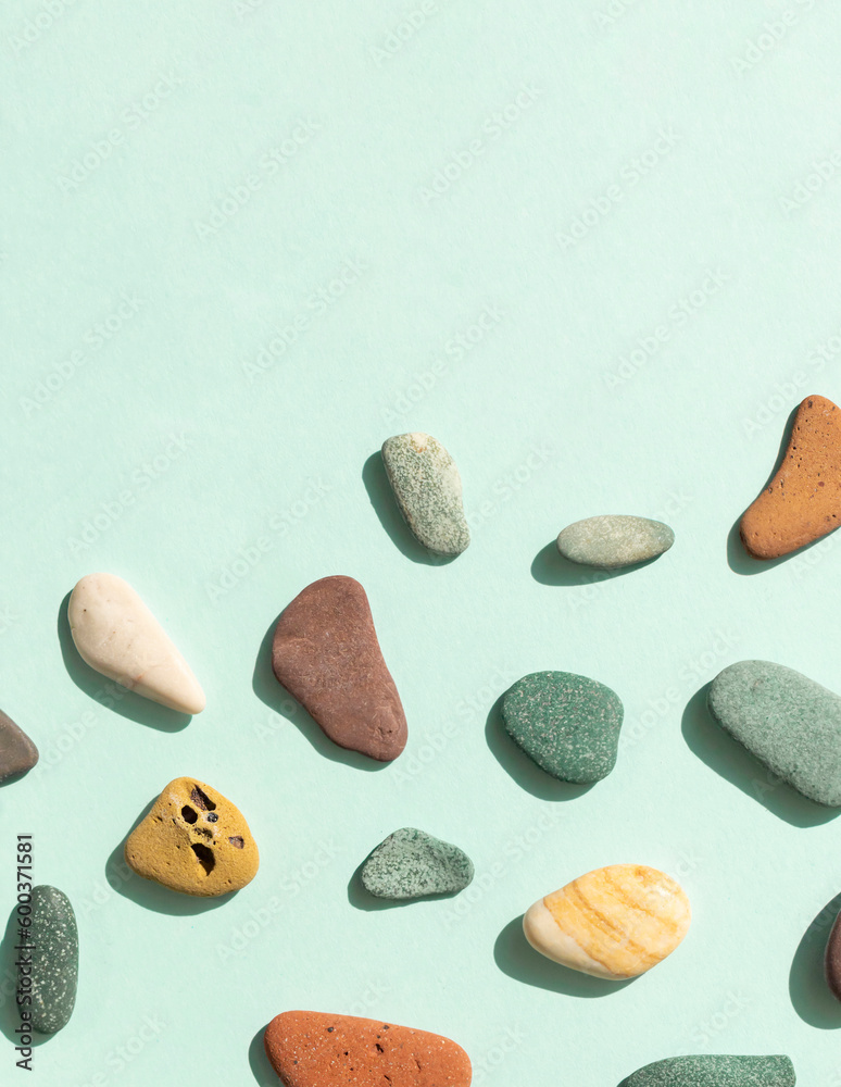 Colorful pebble stones from the sea coast. Top view. Copy space