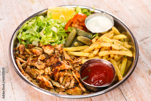 Dajaj chicken Shawarma platter with fries and salad served in dish isolated on table top view fastfood