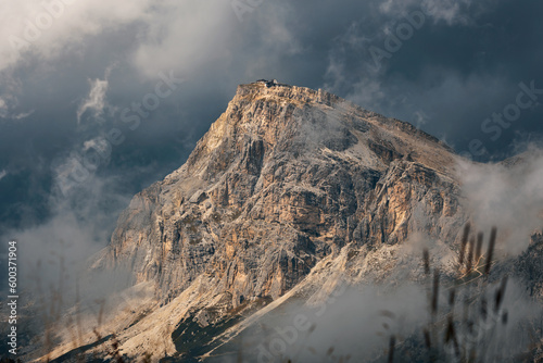 Monte Lagazuoi Piccolo. Dramatic mountain landscape with golden sun and dark clouds. View from Cinque Torri, Dolomites, Italy. Falzarego pass in Dolomiti Ampezzane, Veneto, Alps, Europe. photo