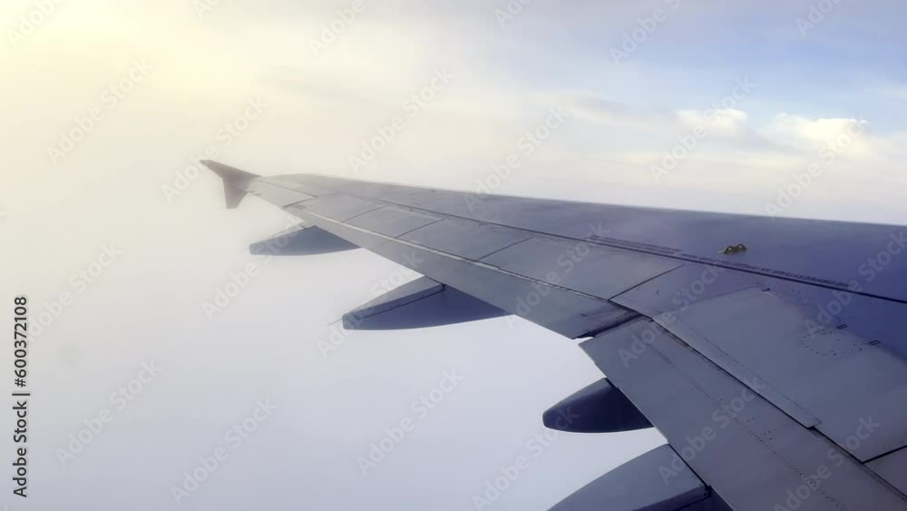A stunning video clip captures the moment an airplane wing emerges from a dense layer of clouds during takeoff, revealing a breathtaking sunrise in the distance. As the wing opens up to the light, the A stunning video clip captures the moment an airplane wing emerges from a dense layer of clouds during takeoff, revealing a breathtaking sunrise in the distance. As the wing opens up to the light, the