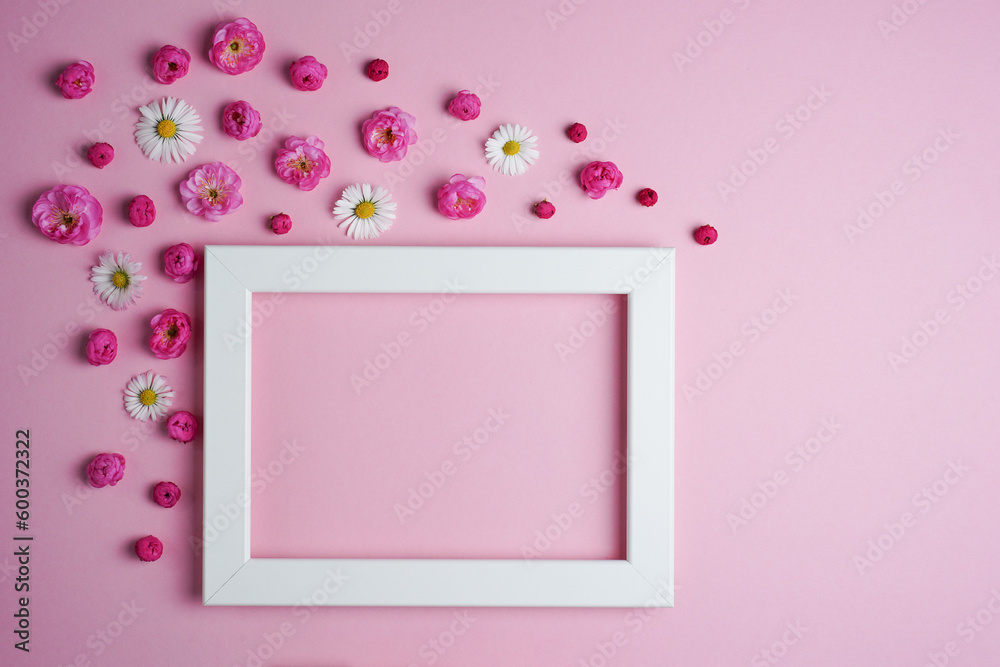 Flat lay, creative layout of blossoms, buds and petals of cherry, plum and daisy flowers with frame on a pink background. Prunus Triloba Louiseania. Mockup for greeting card. Copy space Flat lay, creative layout of blossoms, buds and petals of cherry, plum and daisy flowers with frame on a pink background. Prunus Triloba Louiseania. Mockup for greeting card. Copy space