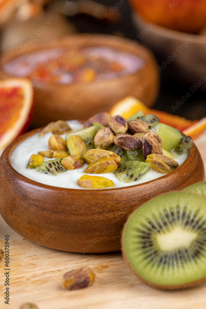 fresh green yogurt with pieces of kiwi and pistachios