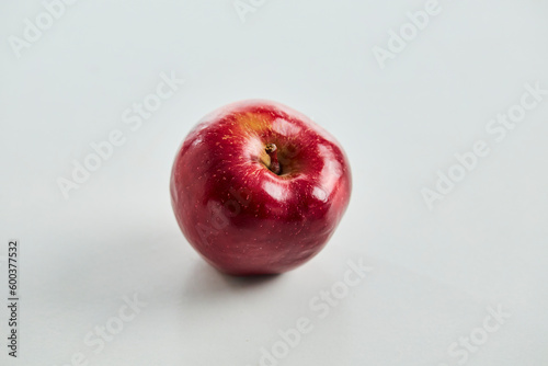 one red apple on a white background