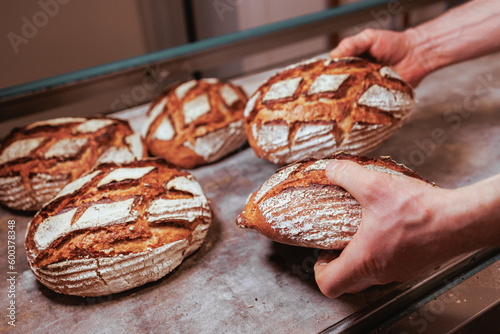 Organic Bakery - details of baker baking bread photo