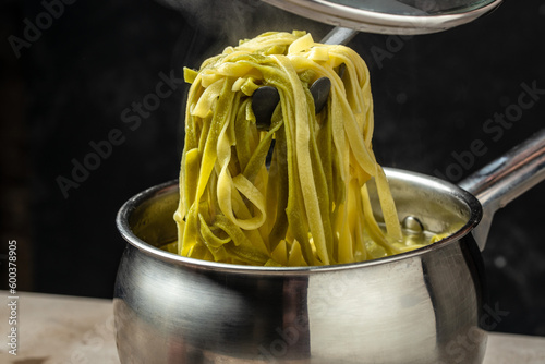 Closeup of boiling spaghetti pasta. put salt and olive oil inside water in the pot