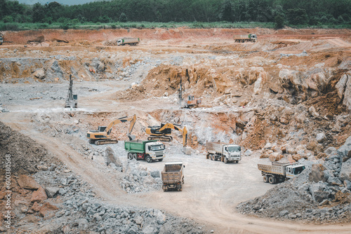 View from above of an open-pit mining quarry with a lot of machinery at work.Copper, silver, gold, and other minerals have been mined in this region. Thailand