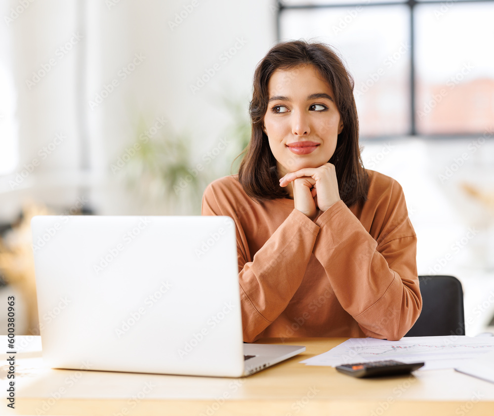 beautiful smiling woman working remotely behind laptop at home beautiful smiling woman working remotely behind laptop at home