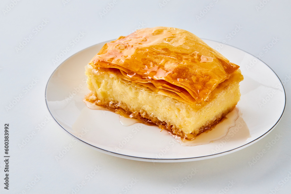 piece of galaktoboureko on a white plate piece of galaktoboureko on a white plate