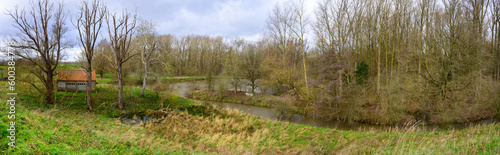 Panorama nature photo of a forest with a winding river in autumn