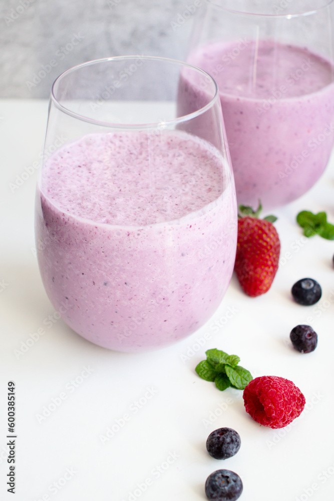 Cocktail with milk, ice cream and berries. On a white background. Deliciously Cocktail with milk, ice cream and berries. On a white background. Deliciously