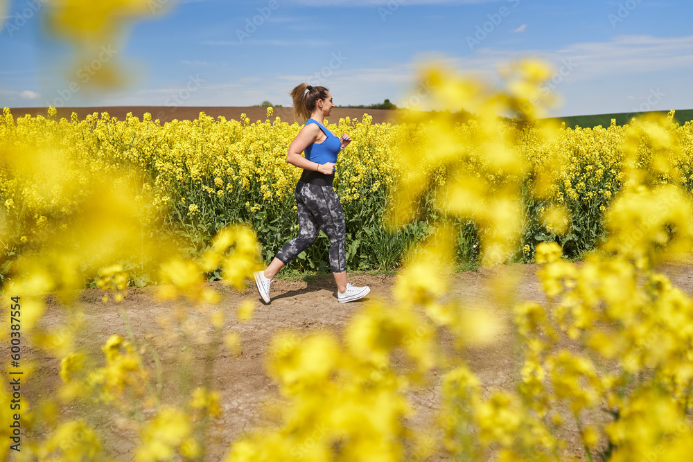 Plus size woman running on a countryside dirt road