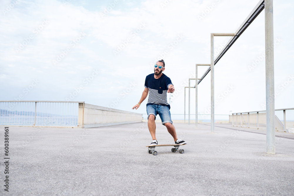 Guy skateboarding on seafront