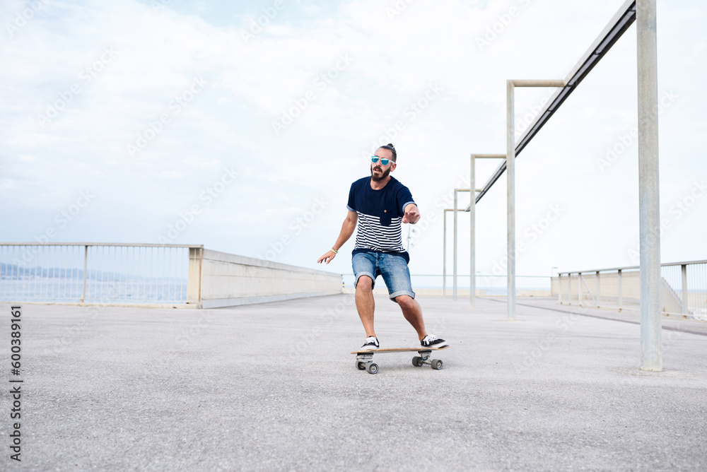 Guy skateboarding on seafront Guy skateboarding on seafront