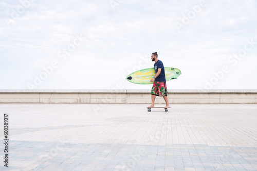 Man with surfing board on longboard