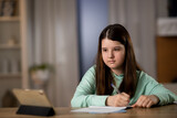E-learning concept. Distant education. Schoolgirl is studying online with digital tablet