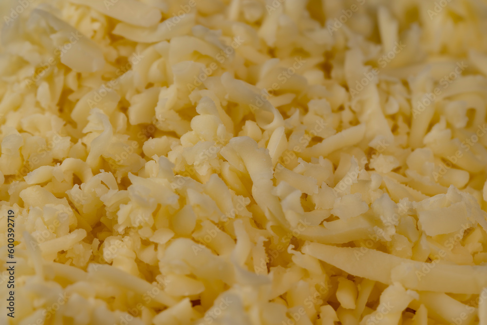 Hard cheese with holes grated into thin small slices Hard cheese with holes grated into thin small slices
