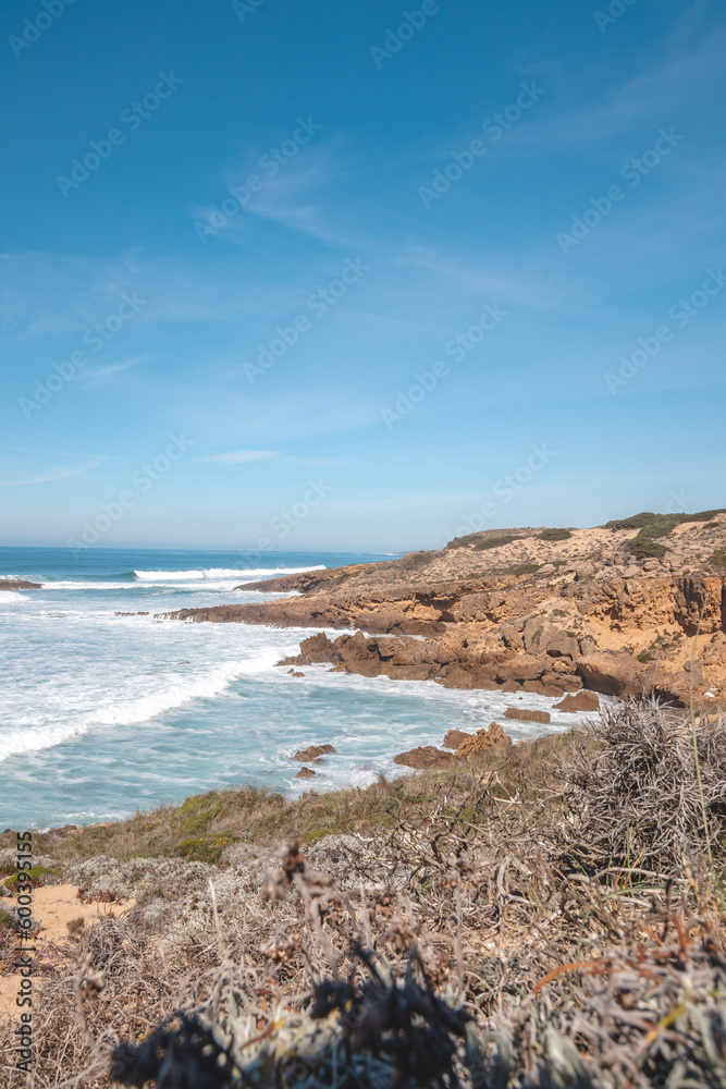 Mountainous and unstable rocky scenery at Atlantic Coast on a sunny day in the Odemira region, western Portugal. Wandering along the Fisherman Trail, Rota Vicentina