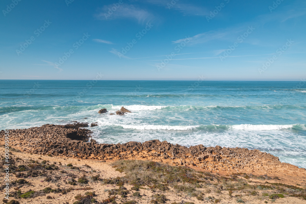 Mountainous and unstable rocky scenery at Atlantic Coast on a sunny day in the Odemira region, western Portugal. Wandering along the Fisherman Trail, Rota Vicentina Mountainous and unstable rocky scenery at Atlantic Coast on a sunny day in the Odemira region, western Portugal. Wandering along the Fisherman Trail, Rota Vicentina