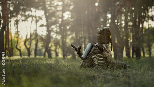 Military backpacks lie in the woods. Background