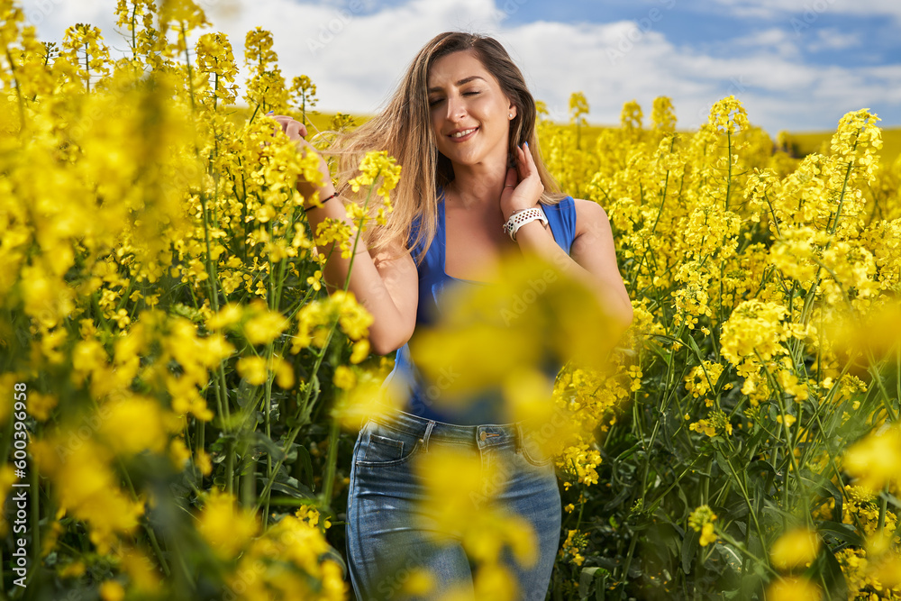 Attractive blonde latino woman in canola field Attractive blonde latino woman in canola field
