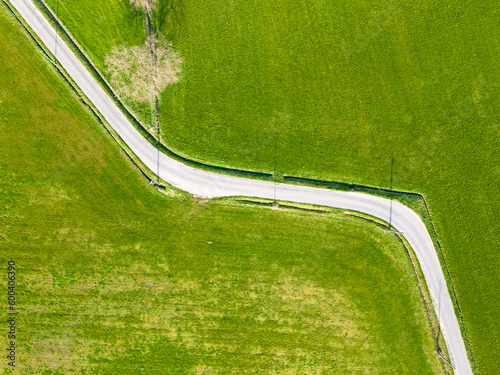 Aerial view of Colorful landscape with road in beautiful green meadows in spring. Top view from above shot with drone, Travel. High quality photo. High quality photo photo