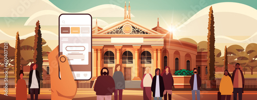 human hand using mobile application on smartphone screen modern governmental building exterior