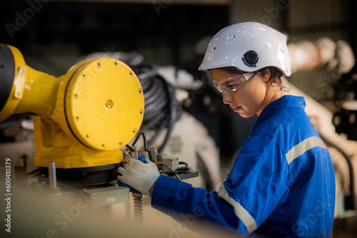 Bild auf Leinwand Caucasian female engineer, technician wearing safety uniform working use tablet Online information to monitor machine operation, check  maintenance plan to make a machine work efficiently and safely