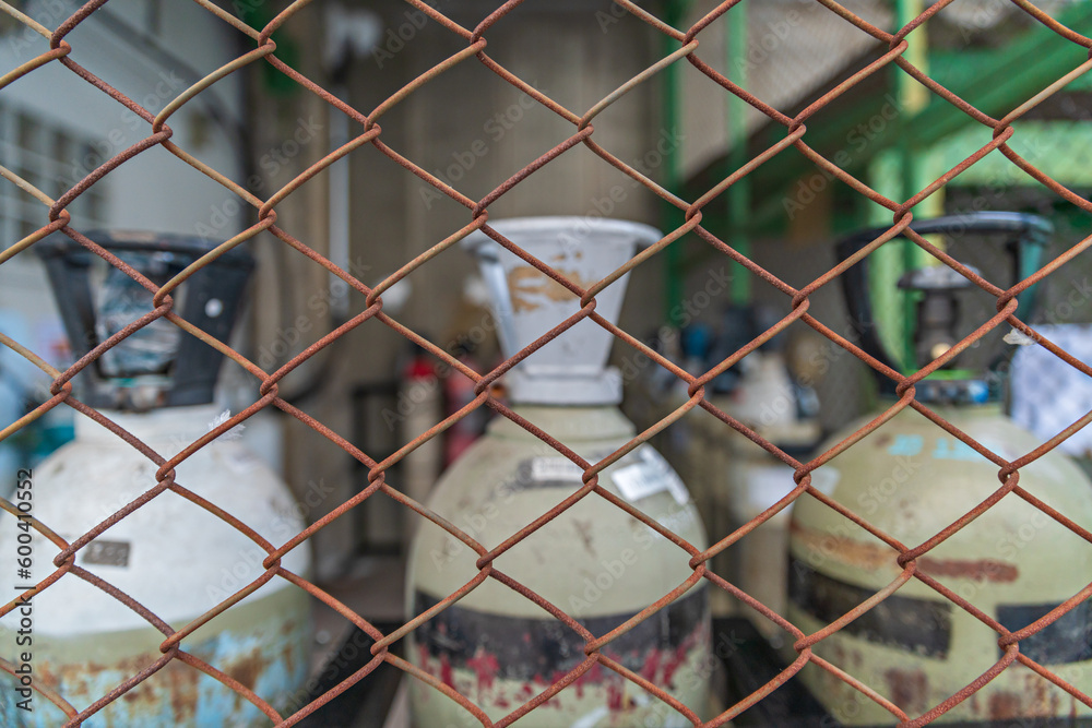 Gas cylinder. Steel mesh for no entry area. Block area around danger