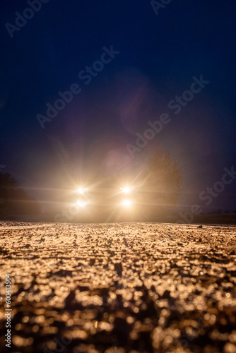 Yellow headlight and dirtroad in the dark after snowing. Car driving on a dangerous road in dire circumstances. High quality photo