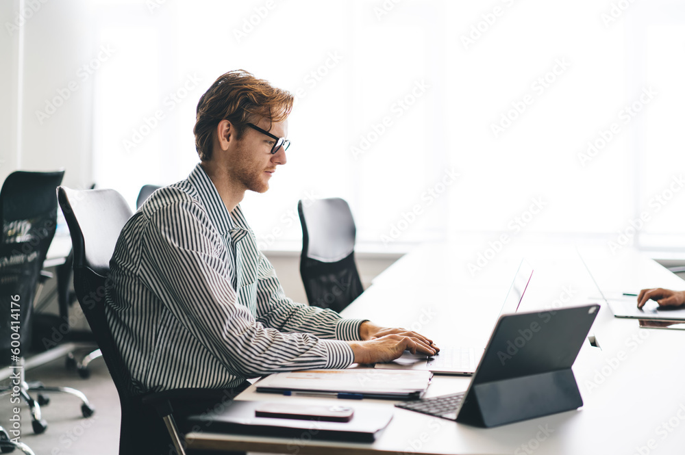 Busy man working on laptop in office Busy man working on laptop in office
