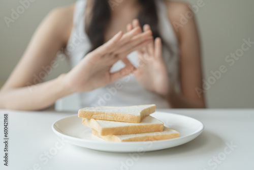 food intolerance concept, young women anxiety before eating bread worrying about gluten intolerance in the bread. photo