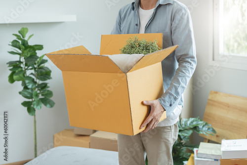 People relocation move home concept, Man carrying belongings box moving in new apartment Fototapet