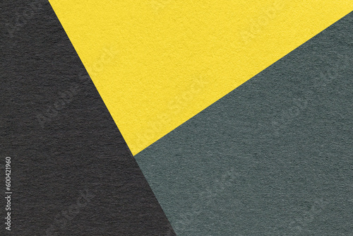 Texture of craft black, green and yellow shade color paper background, macro. Vintage abstract cardboard