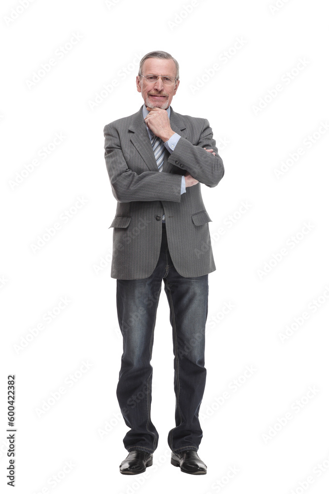 Senior man stands, arms crossed, with one hand on chin in thoughtful full length pose