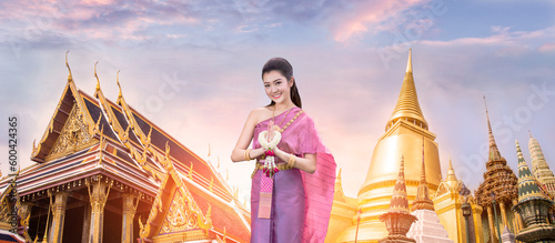 Beautiful asain woman gretting with Wat Phra Kaew, Emerald Buddha temple in background photo