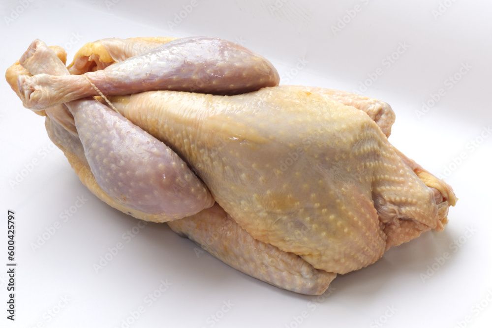 Close up on raw farm guinea fowl ready to cook on white background. Close up on raw farm guinea fowl ready to cook on white background.