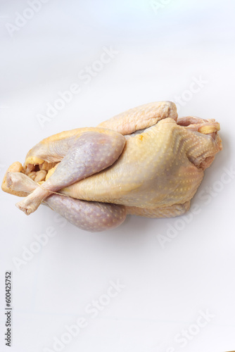 Close up on raw farm guinea fowl ready to cook on white background.