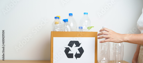 Volunteer keep plastic bottle into paper box at home or office. Hand Sorting Recycle garbage. Ecology, Environmental, pollution, Dispose recycling, waste management and trash Separation concept