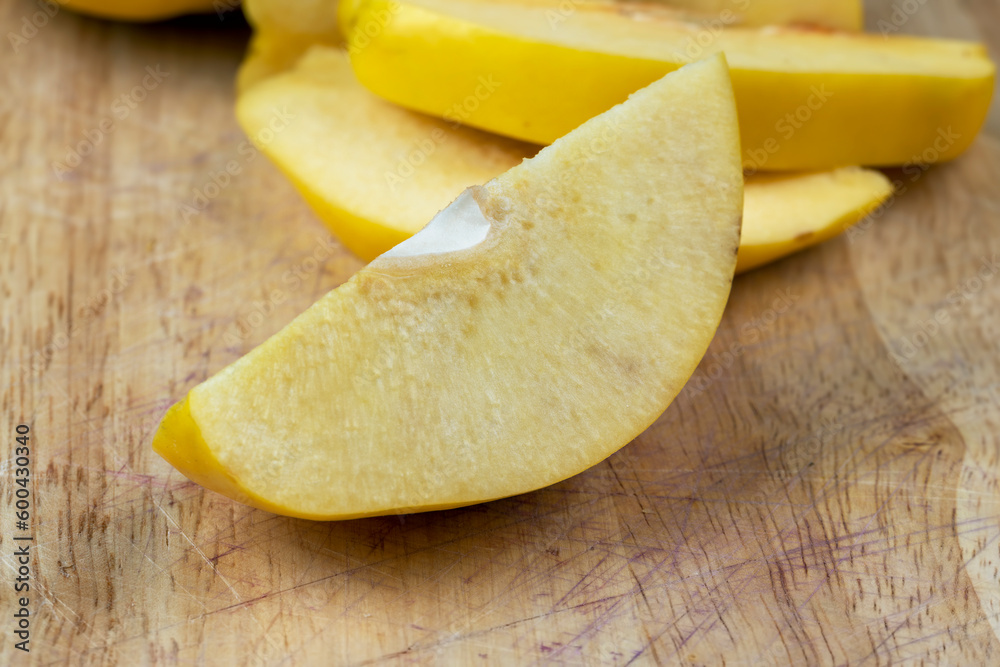 Sliced ripe yellow quince on a cutting board Sliced ripe yellow quince on a cutting board