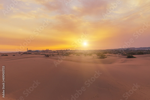 Maspalomas Dunes on tropical Gran Canaria island Exceptional desert-like atmosphere with vast expanse of undulating sand dunes that stretch for miles.Picturesque view particularly enchanting at sunset